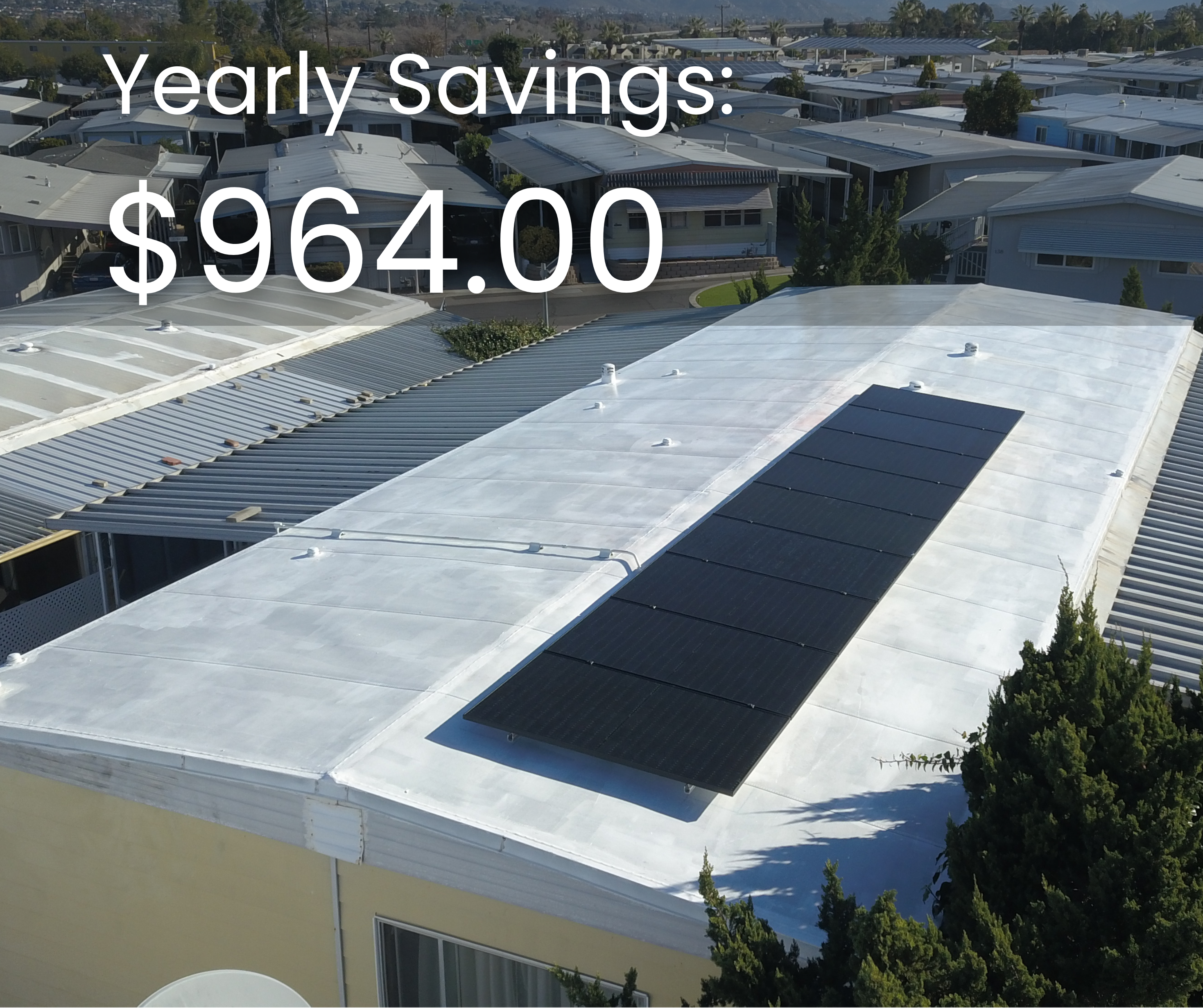 Yearly savings of $964 displayed on a solar panel installation atop a mobile home, showcasing the benefits of solar energy for homeowners.