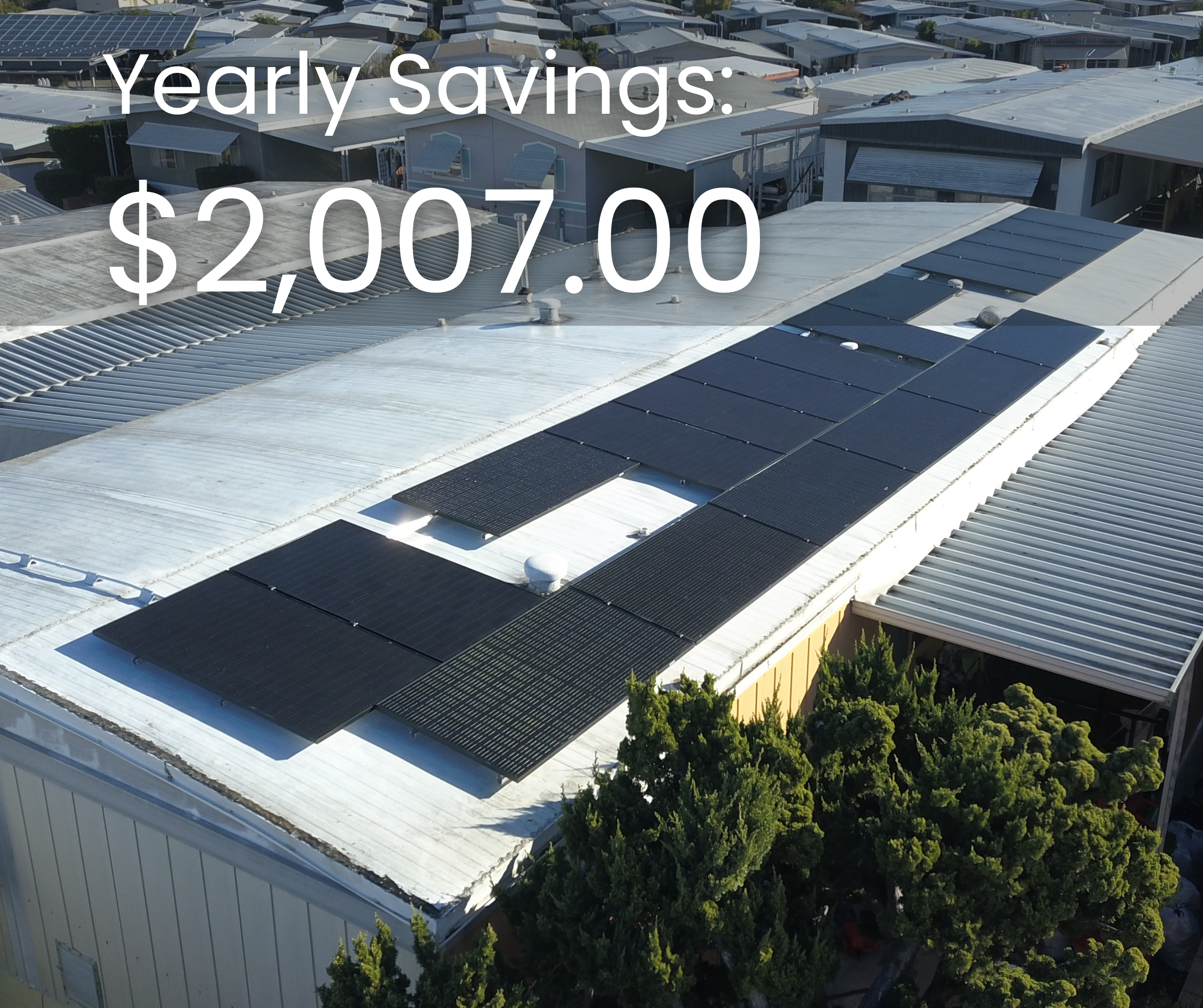 Solar panels installed on a mobile home roof showcasing yearly savings of $2,007, emphasizing affordable solar energy solutions.